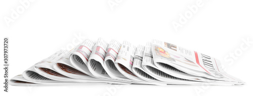 Many newspapers on table against white background photo