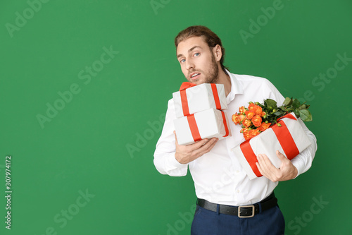 Handsome man with flowers a...