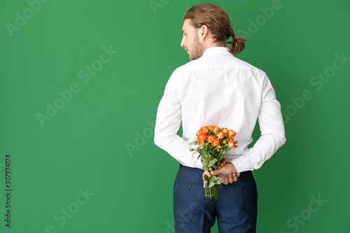 Handsome man with flowers o...