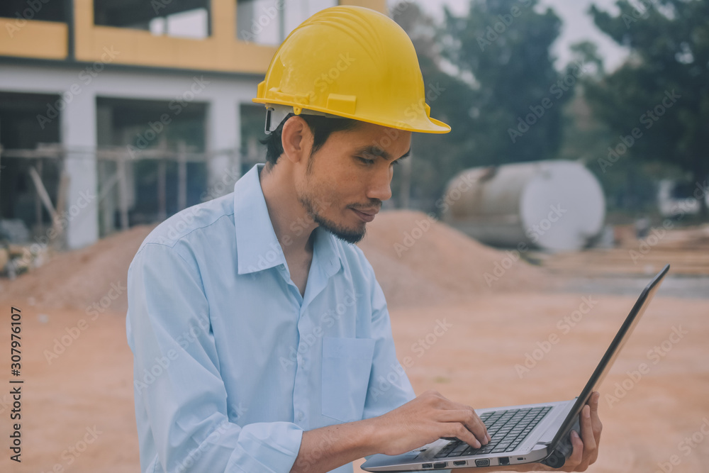 Project Engineering construction use computer notebook working on site management Project Engineering construction use computer notebook working on site management
