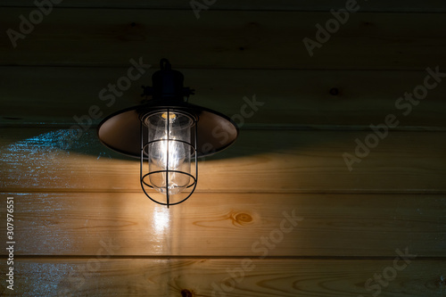 Vintage wall lamp on wooden wall texture interior lighting bulbs decoration contemporary