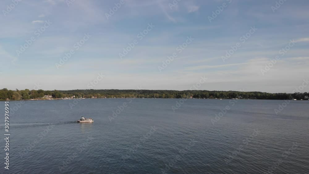 Beautiful aerial plane of a ship on the lake, a drone closely follows the movement of the ship that leaves a wake of the engine in its wake Beautiful aerial plane of a ship on the lake, a drone closely follows the movement of the ship that leaves a wake of the engine in its wake