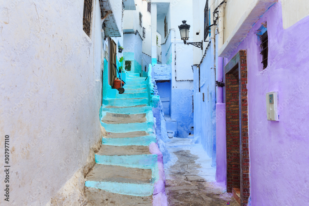 View of the colorful old walls of Tetouan Medina quarter in Northern Morocco. A medina is typically walled, with many narrow and maze-like streets and often contain historical houses, palaces, places. View of the colorful old walls of Tetouan Medina quarter in Northern Morocco. A medina is typically walled, with many narrow and maze-like streets and often contain historical houses, palaces, places.