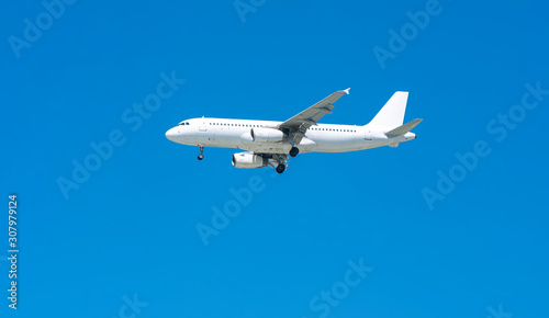 Airplane through blue sky prepare to landing