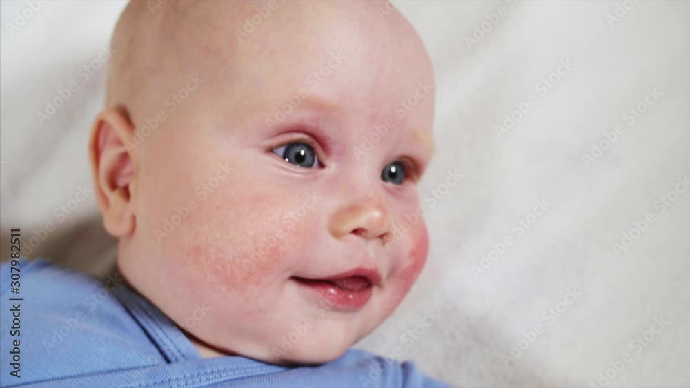 Top close portrait of sweet smiling 3-weeks old baby boy with blue eyes Top close portrait of sweet smiling 3-weeks old baby boy with blue eyes