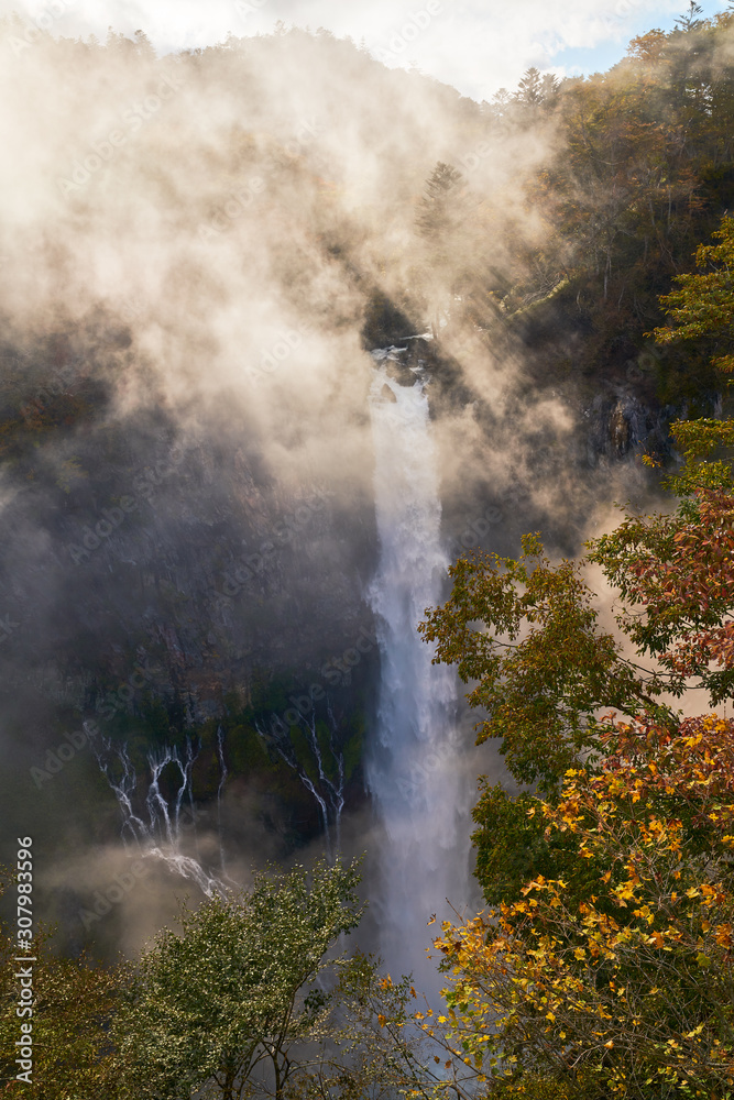 Obraz premium wonderful view of kegon waterfall with fog and sun light in autumn nikko