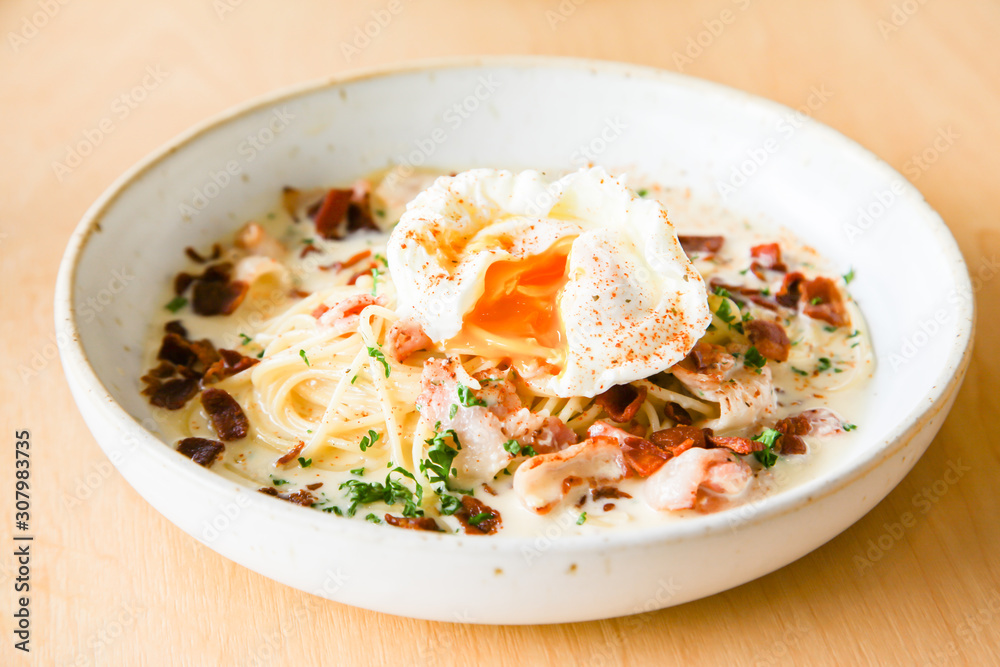 Pasta cream sauce with bacon and poached egg Pasta cream sauce with bacon and poached egg