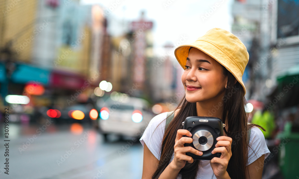 Asian traveler woman hold instant camera