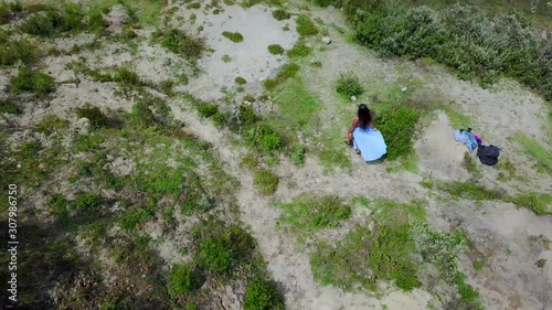 Aerial shot woman running at Quilotoa, Ecuador caldera in the Andes Mountains.