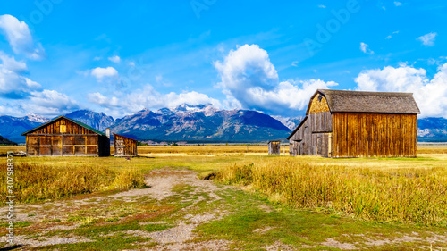 Abandoned Barns at Mormon Row with in the background cloud covered Peaks of the Grand Tetons In Grand Tetons National Park near Jackson Hole, Wyoming, United States