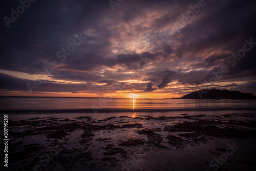 Purple sunset by a beach