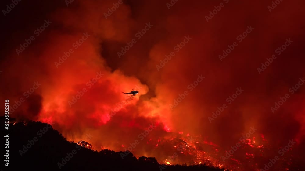 2019 - a helicopter makes a dramatic water drop at night responding to the Cave Fire near Santa Barbara, California.