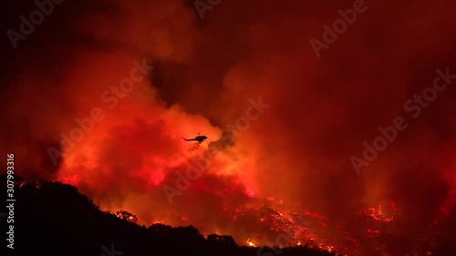 2019 - a helicopter makes a dramatic water drop at night responding to the Cave Fire near Santa Barbara, California.