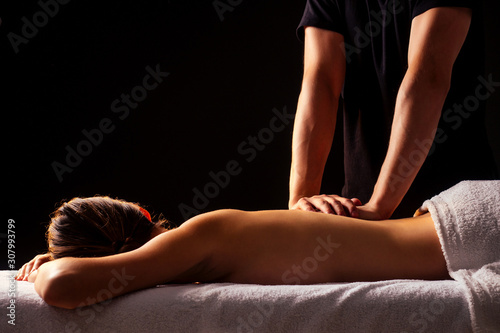 woman having back therapy yoga massaging in gym spa