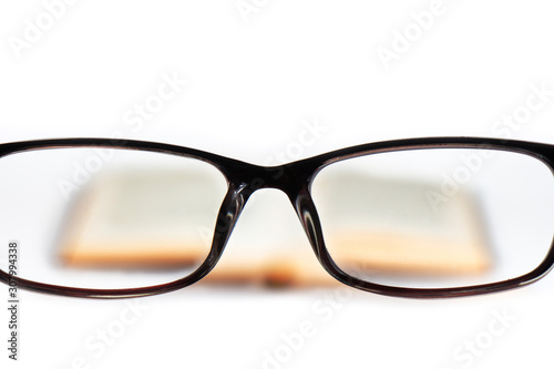 Glasses open book white background