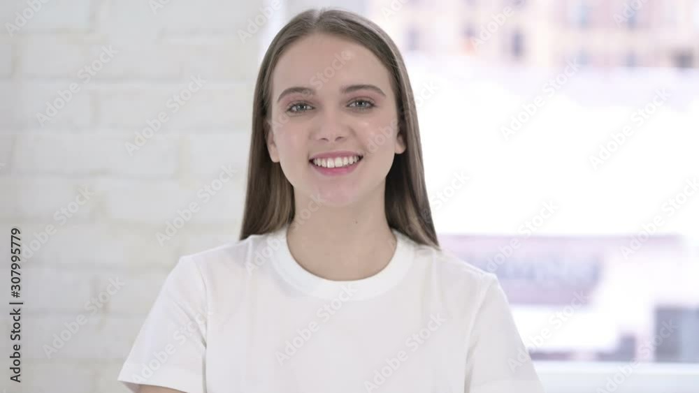 Portrait of Beautiful Young Woman Saying Yes by Head Shake Portrait of Beautiful Young Woman Saying Yes by Head Shake