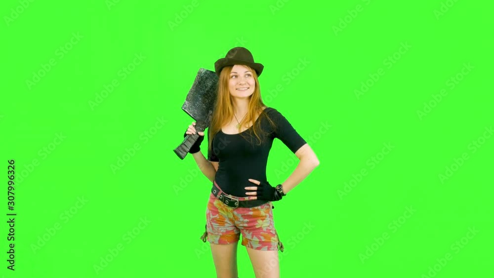 happy girl in a hat looks around victoriously around with a large ax on her shoulders green screen happy girl in a hat looks around victoriously around with a large ax on her shoulders green screen