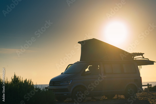 Obraz na plátně Camper van with tent on roof at sunset