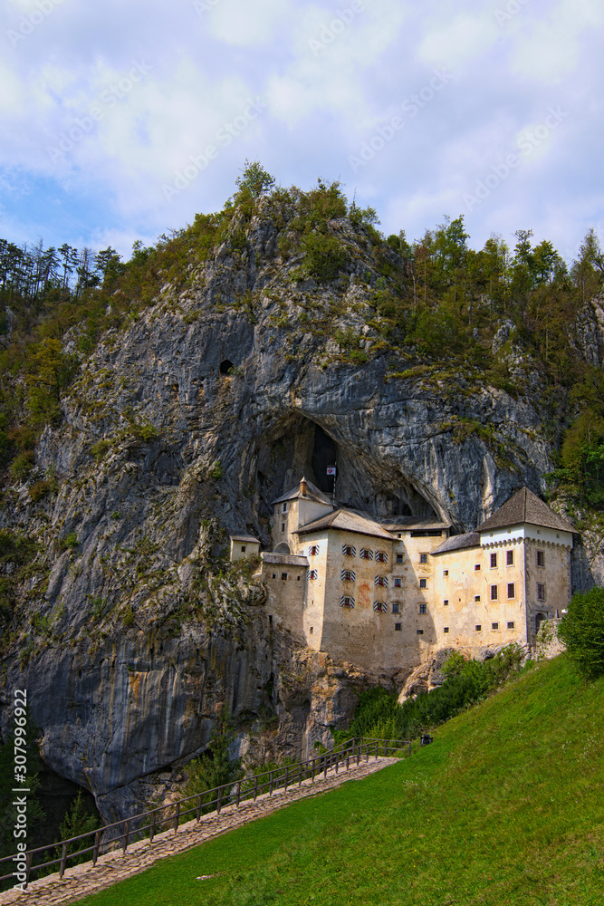 Magic landscape of medieval Predjama castle (Slovene. Predjamski grad). Renaissance castle built within a cave mouth. Travel and tourism concept. Predjama Village, Slovenia