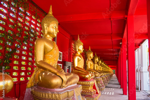 Uthai Thani, Thailand - November, 30, 2019 : Row of golden sitting buddha statues in temple at Uthai thani province, Thailand