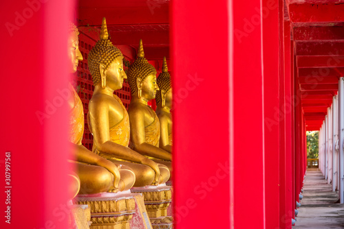 Uthai Thani, Thailand - November, 30, 2019 : Row of golden sitting buddha statues in temple at Uthai thani province, Thailand © bubbers