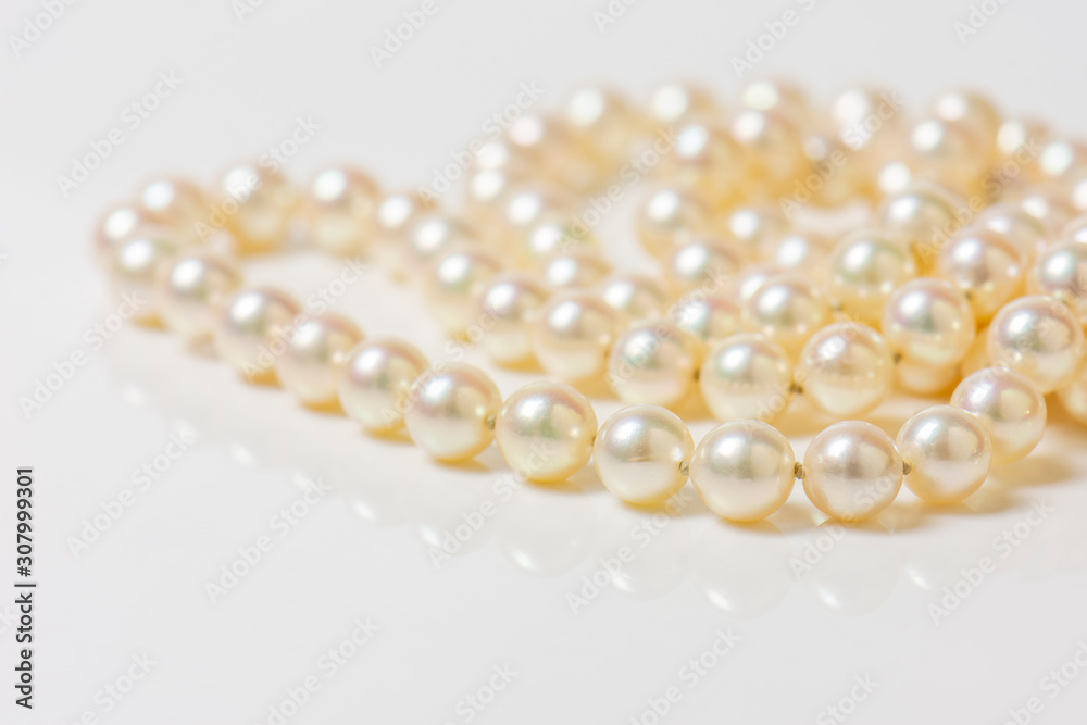 Close up of sphere natural pearl necklace on white background. Selective focus.