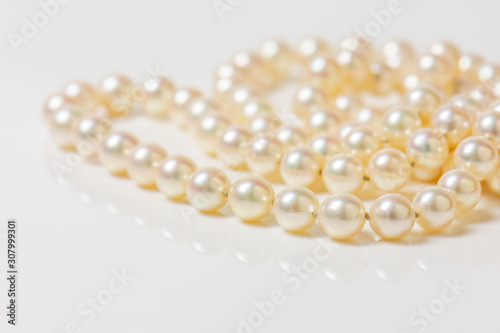 Close up of sphere natural pearl necklace on white background. Selective focus.