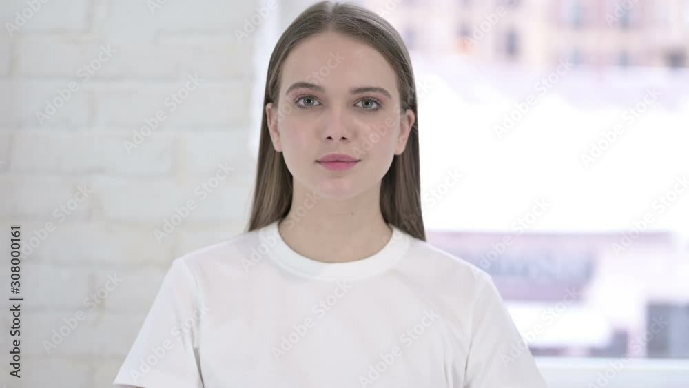 Portrait of Serious Young Woman Looking at the Camera Portrait of Serious Young Woman Looking at the Camera