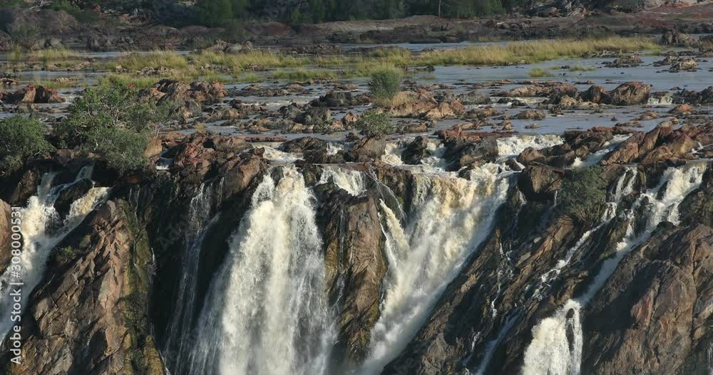 famous Ruacana waterfalls on the Kunene River, Northern Namibia border, Africa wilderness landscape, Waterfall is full of water after rain season. famous Ruacana waterfalls on the Kunene River, Northern Namibia border, Africa wilderness landscape, Waterfall is full of water after rain season.