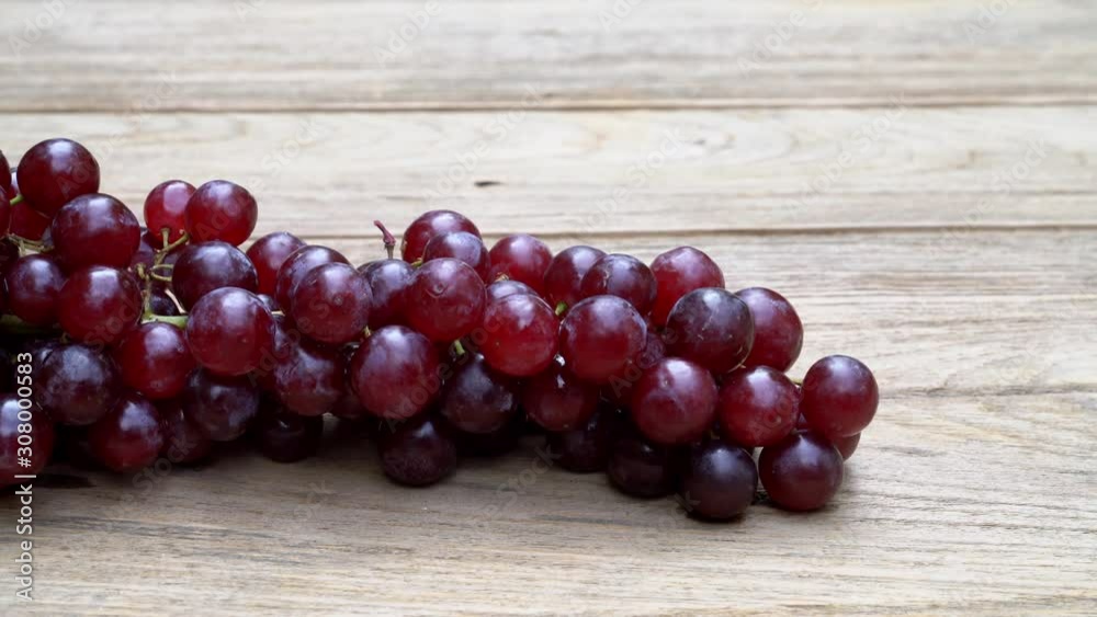 Red grape on a wooden table ,Right-to-left pan shot Red grape on a wooden table ,Right-to-left pan shot