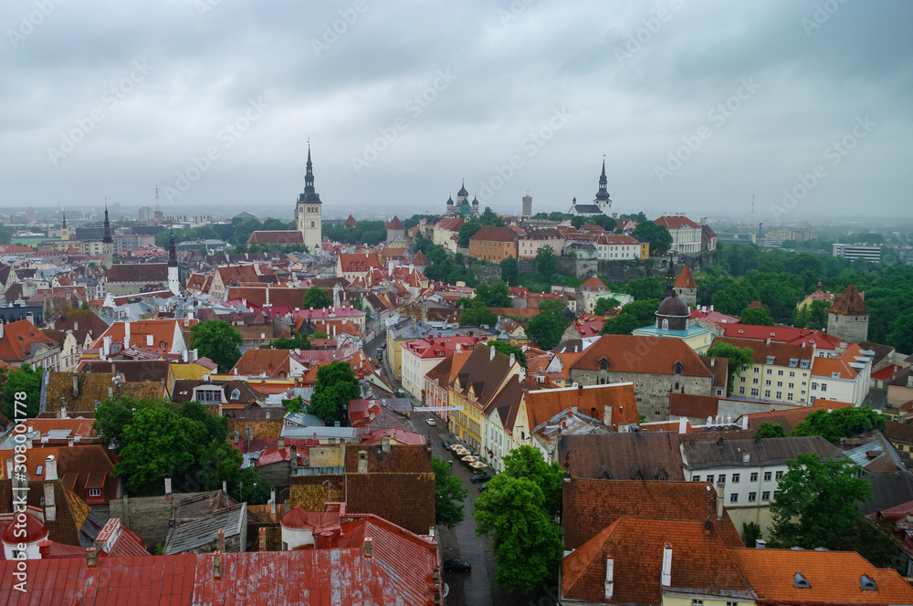 Tallinn Old Town and Toompea Hill, Estonia, panoramic view on rainy weather with traditional red tile roofs, medieval churches and walls.