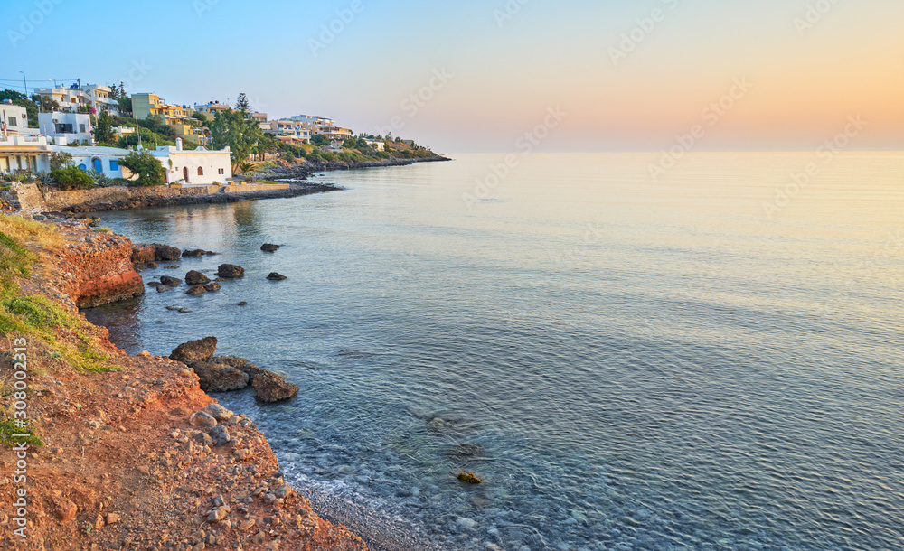 Beautiful summer sunrise on island Crete. Village on the coast of the Aegean Sea.