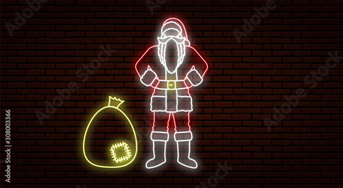Neon christmas sign. Santa Claus in red clothes. Holds hands on a belt. Against the background of a brick wall. With a darned bag of gifts.