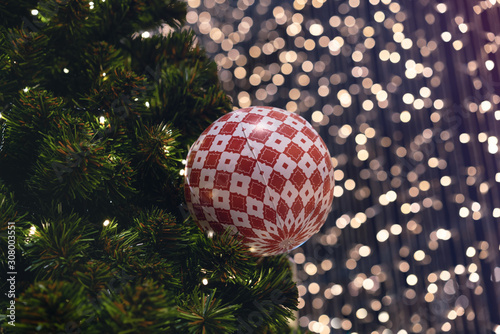 Картината върху платно Christmas ball decoration hanging on festive xmas tree with bokeh out of focus b