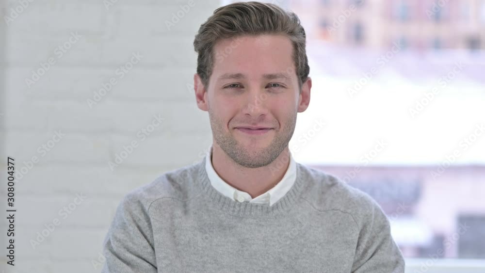 Portrait of Creative Young Man saying Yes by Shaking Head Portrait of Creative Young Man saying Yes by Shaking Head