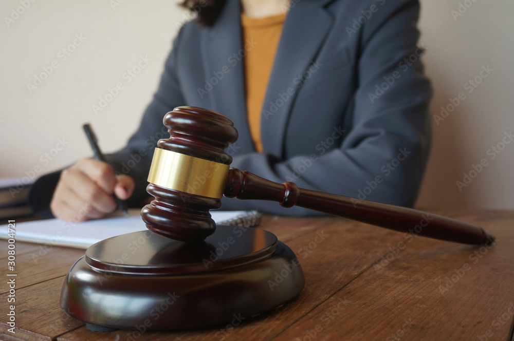 Legal counsel presents to the client a signed contract with gavel and legal law. justice and lawyer law of advisor Concepts