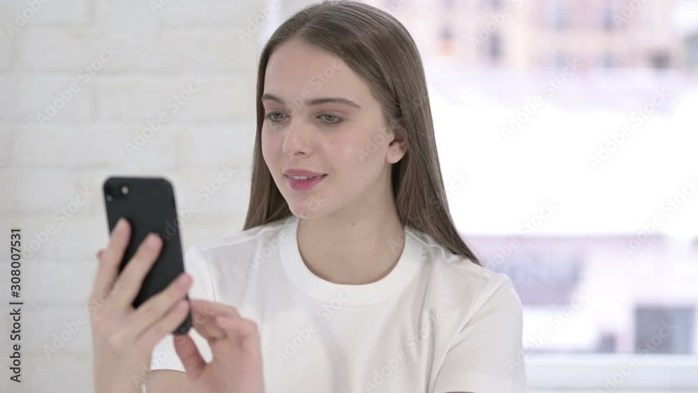 Portrait of Focused Young Woman using Smartphone Portrait of Focused Young Woman using Smartphone