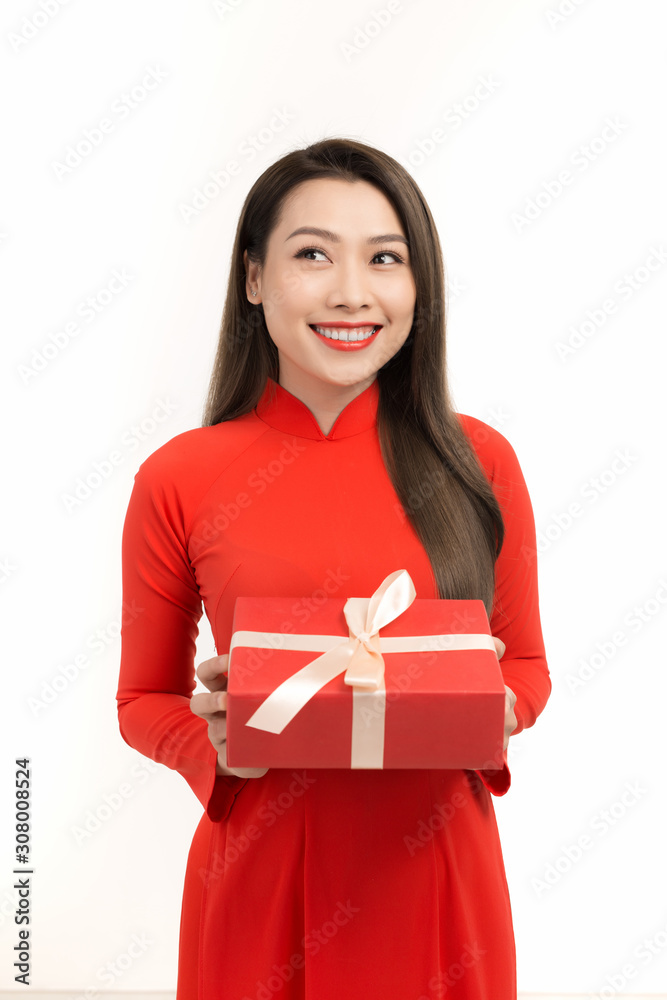 Fototapeta premium Asian girl with Vietnamese traditional dress holding gift box, Lunar New Year Greetings