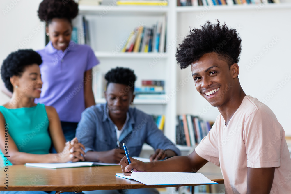 Young african american male student learning at desk at school Young african american male student learning at desk at school