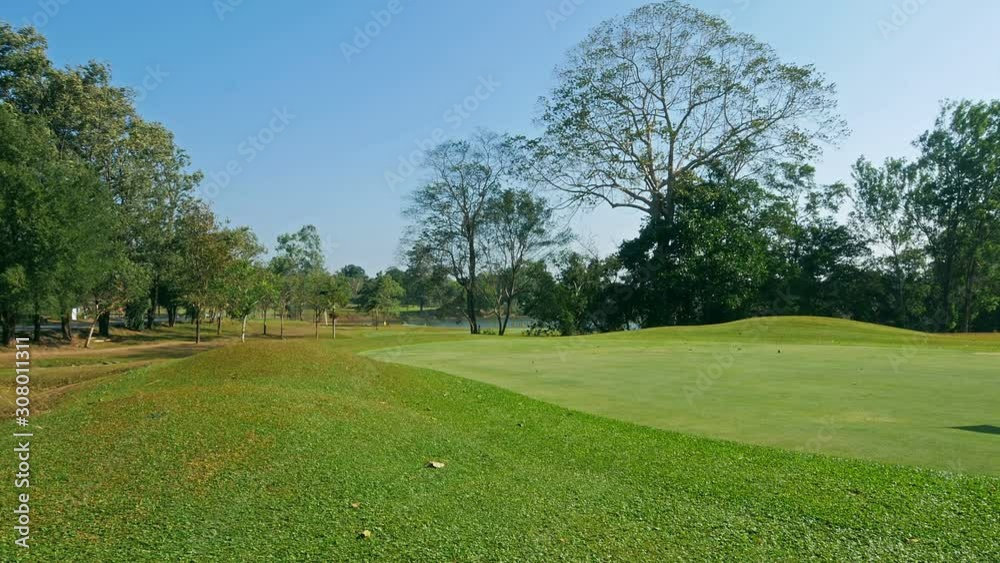 Beautiful golf course on a sunny day with blue sky during strong wind. Beautiful fairway on sunny day. Beautiful golf course on a sunny day with blue sky during strong wind. Beautiful fairway on sunny day.