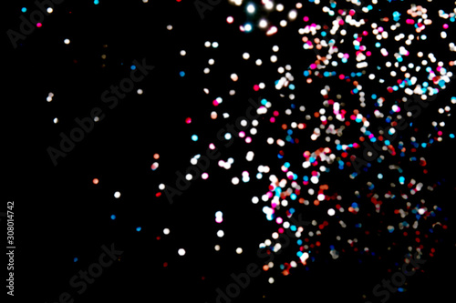 Black background with bright multicolor bokeh lights. Holiday  Christmas and New Year background. Ideal to layer with any design. Horizontal