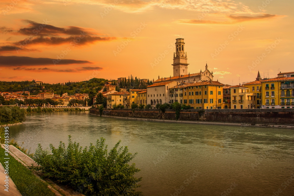 View of the historic city center along Adige river at sunset in Verona, Italy.