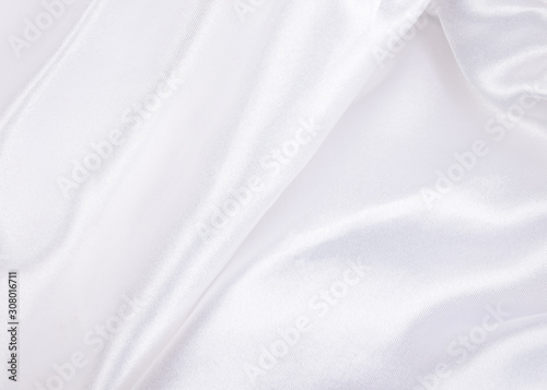Extreme macro shot of folded white silk (as an abstract curved background or silk texture), shallow DOF, selective focus