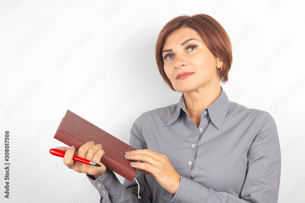 business girl with a red pen and notebook in hands on a white background business girl with a red pen and notebook in hands on a white background