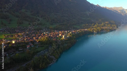 Horizontal aerial panning footage of Ringgenberg, a municipality in Switzerland, located beside Lake Brienz, Interlaken. photo