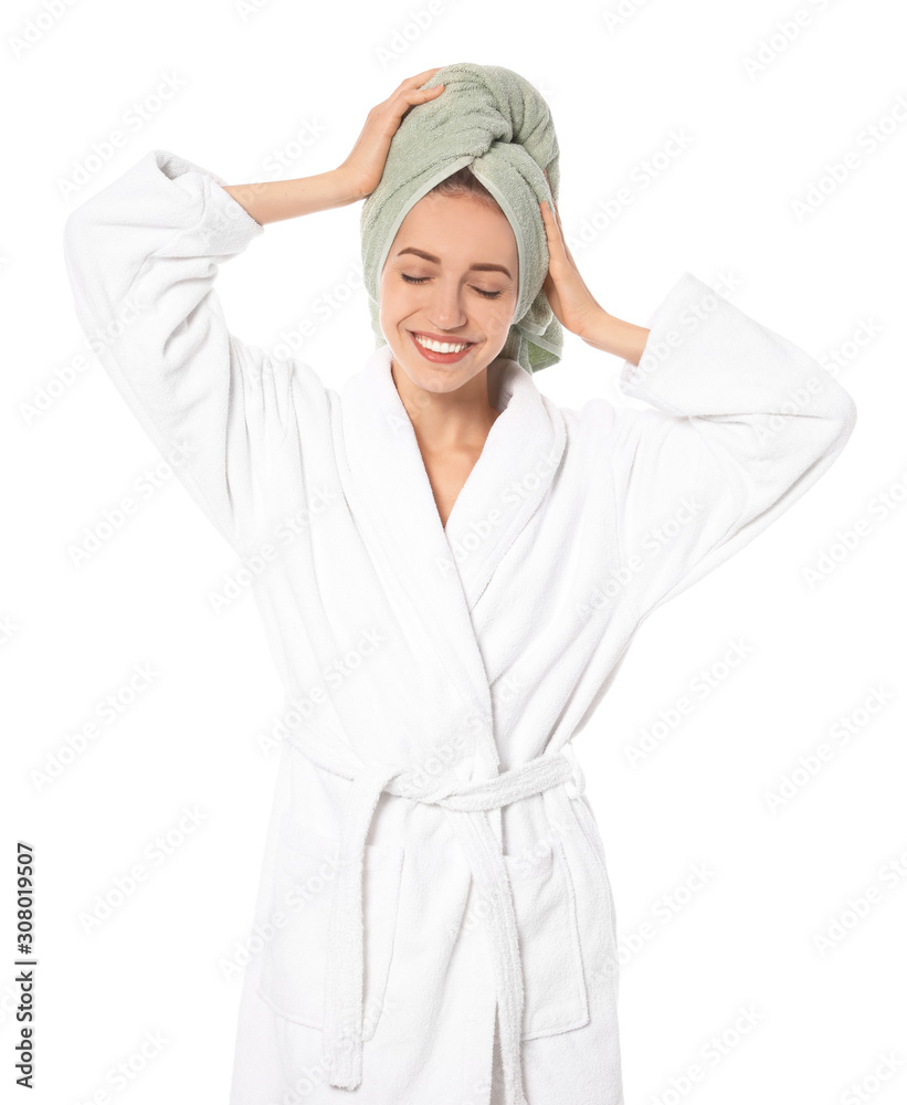 Beautiful young woman wearing bathrobe on white background