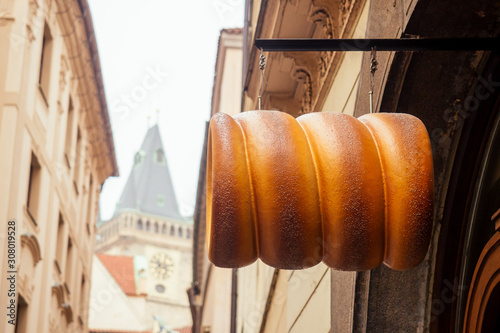 Photography woman with an appetite eats a traditional Czech sweet Trdelnik in Prague street