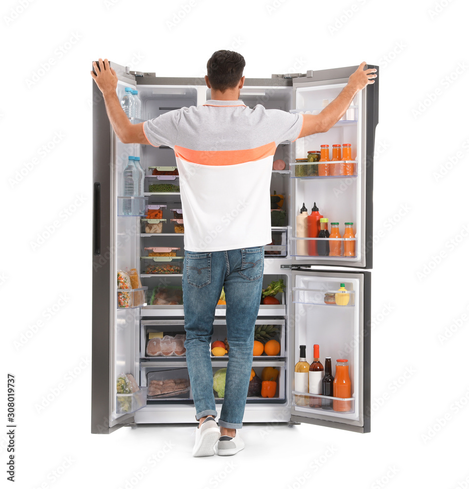 Man near open refrigerator on white background, back view Man near open refrigerator on white background, back view