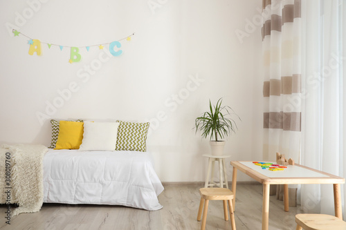 Modern child room interior with comfortable bed photo