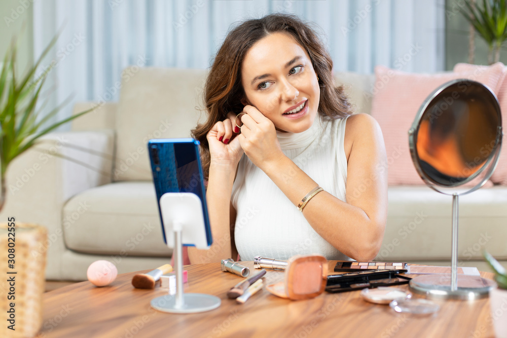 Young attractive woman doing live webcast at home. Young attractive woman doing live webcast at home.
